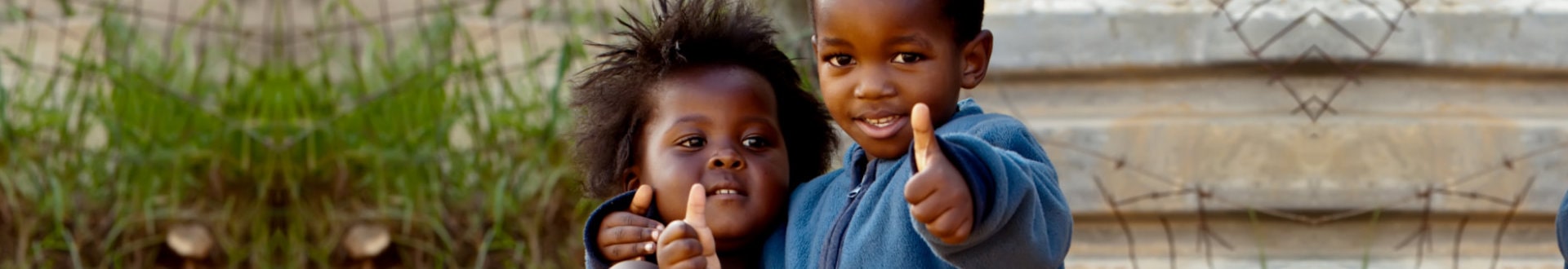 two children giving a thumbs up