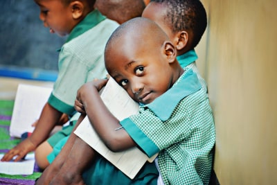 little boy staring outside of the classroom